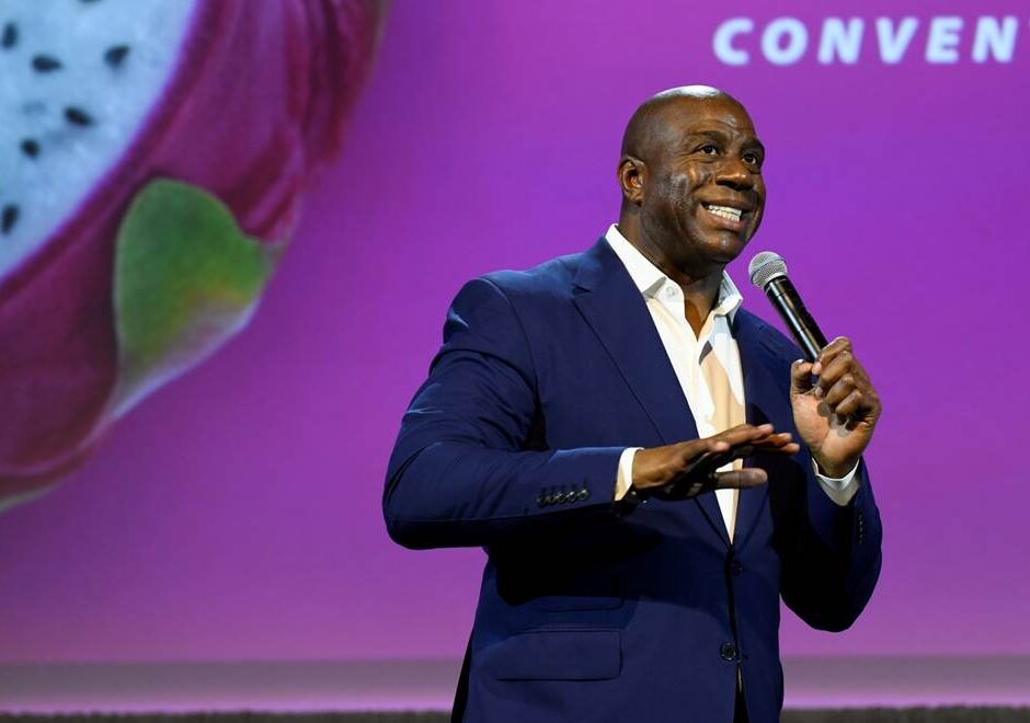 Business celebrity speaking on stage at a corporate event about the hidden costs of event planning