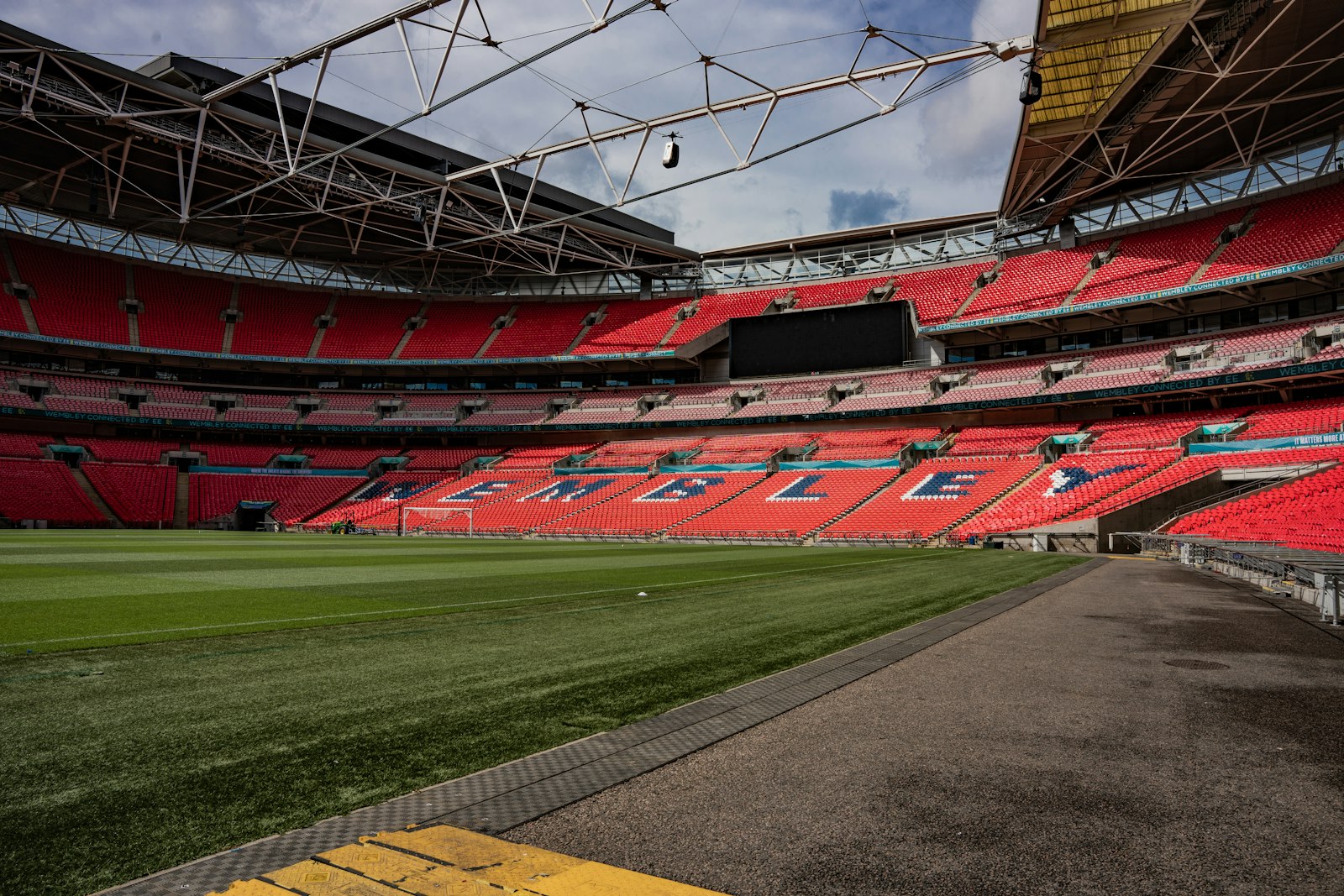 Empty stadium with red seats, representing how to book an athlete for a corporate event