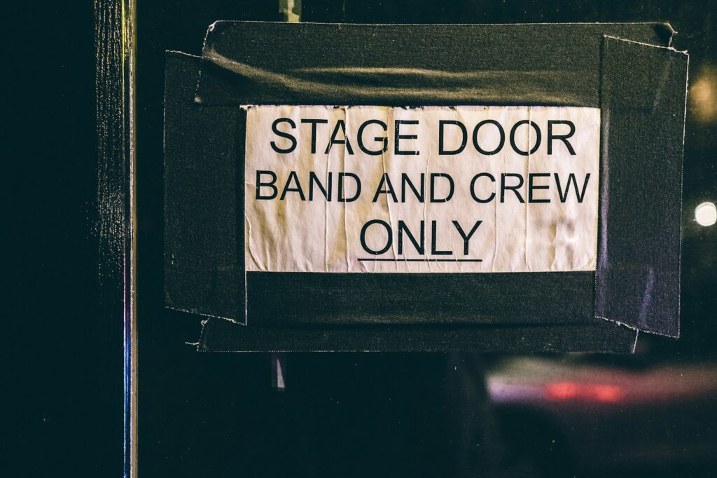 Celebrity rider explained: stage door with band and crew only sign
